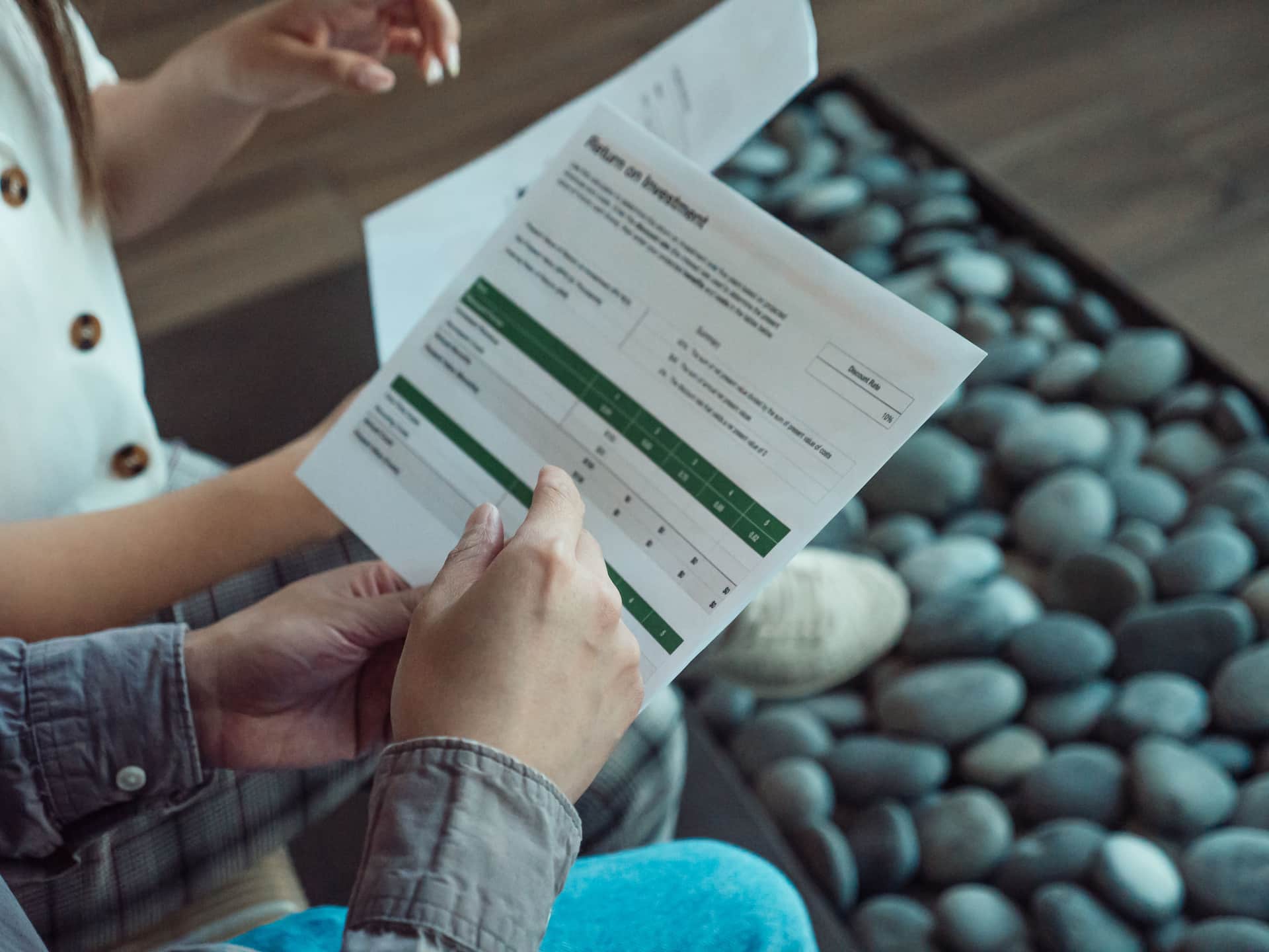 A printed table of specification figures photographed under hard light