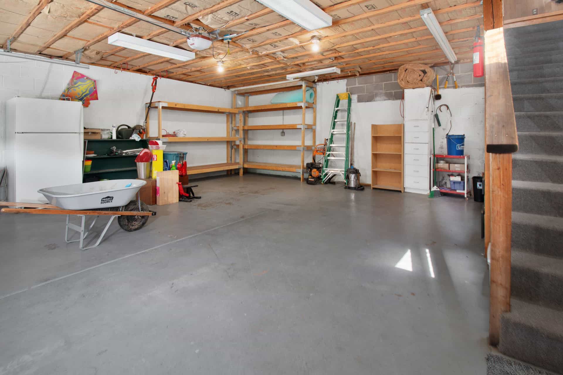 An empty concrete-floored garage lit from one side