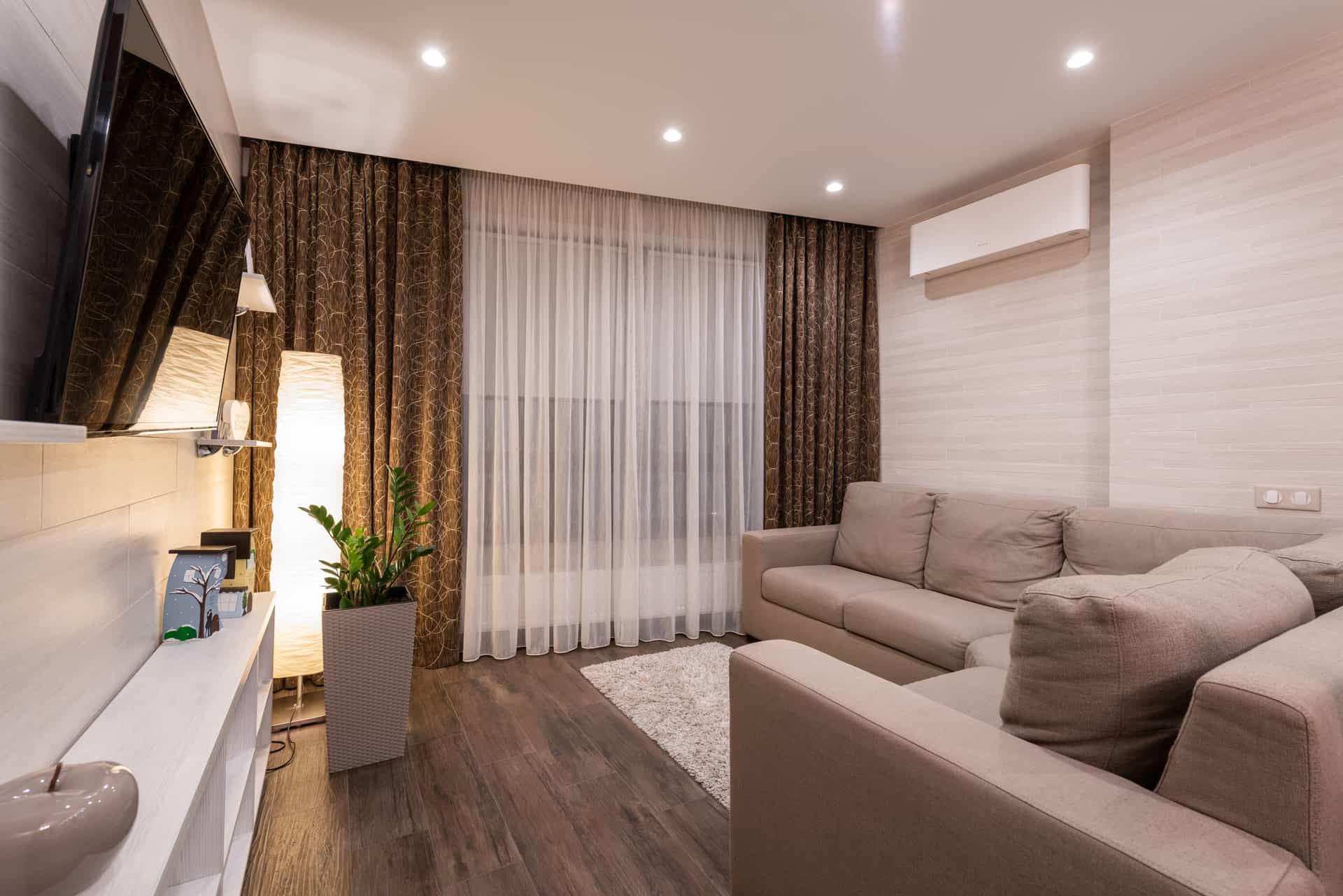 An air purifier standing in a plainly furnished room